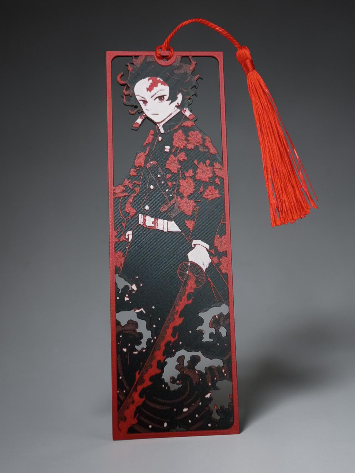 Marque-page style manga japonais encadré en impression 3D rouge noir et blanc avec pompon rouge