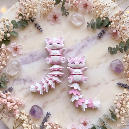 Quatre modèles de chats articulés avec queues composées de pétales roses et blancs
