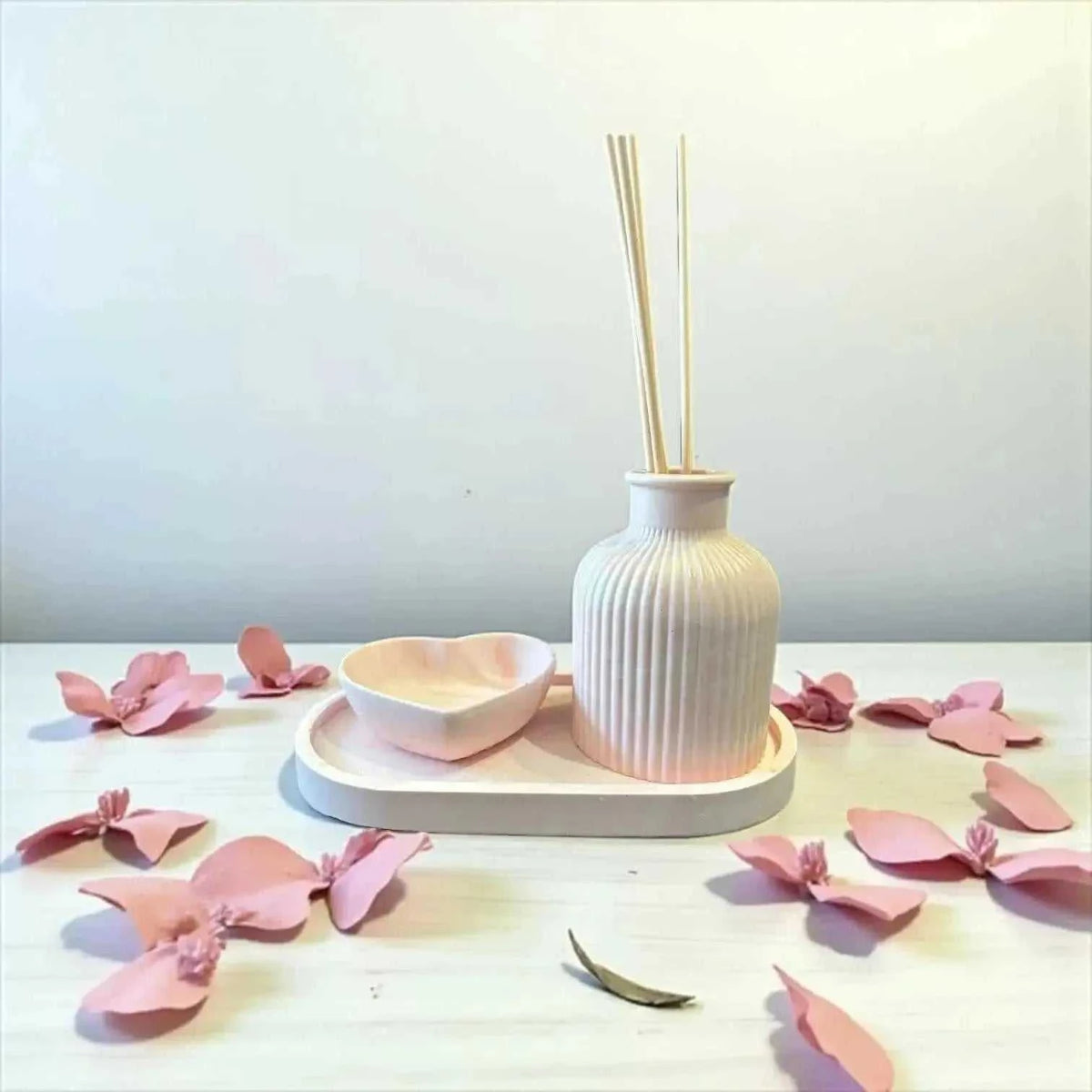 Diffuseur à Parfum en Jesmonite rose pastel marbré blanc avec rainures, plateau ovale et cœur vide-poche assortis, finition mate douce.