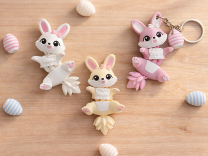 Trois lapins de Pâques articulés Fluffy Tails sur bois avec œufs pastel