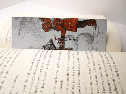 Marque-page de Noël modèle fille construisant un bonhomme de neige placé dans un livre