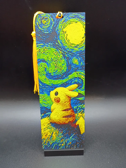Marque-page Pikachu Starry Night avec pompon jaune sur fond noir