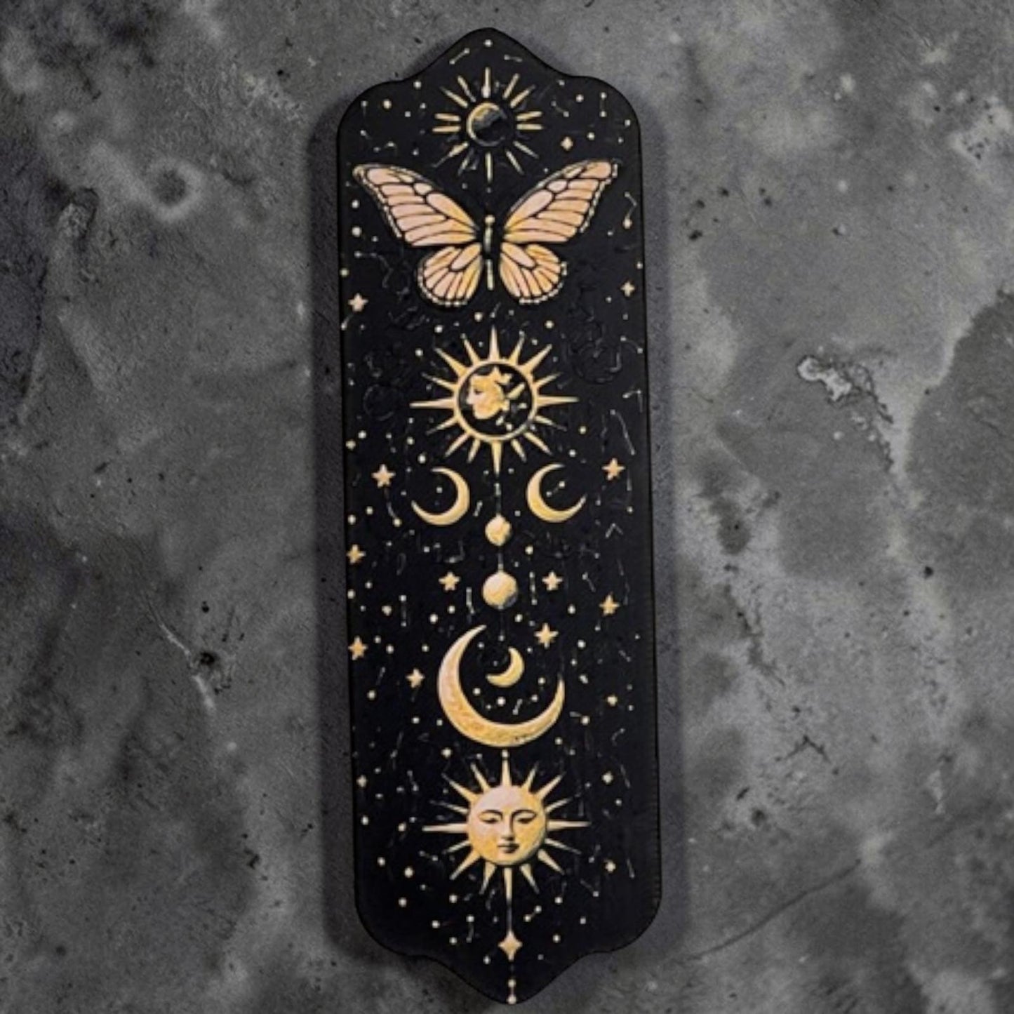 Marque-page papillon céleste en impression 3D avec motifs lune, soleil et étoiles sur fond noir